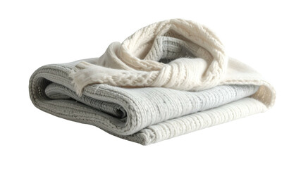 Folded knit blankets and scarf, soft shades of grey and white