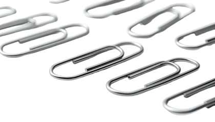 Scattered metal paperclips against stark black background