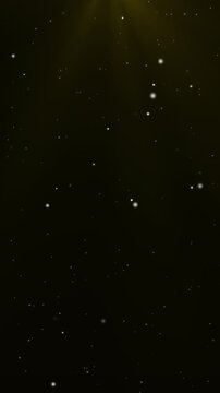 Vertical background video with sparkling light particles shining in gold light