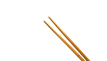 Two chopsticks slanted against a black backdrop
