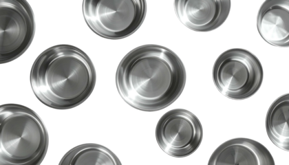 Silver metallic bowls are scattered on a dark surface, top view