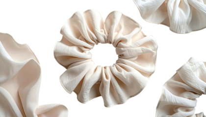 Creamy fabric scrunchies arranged on black
