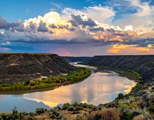 Scenic river winding through deep canyon under dramatic, cloudy sky
