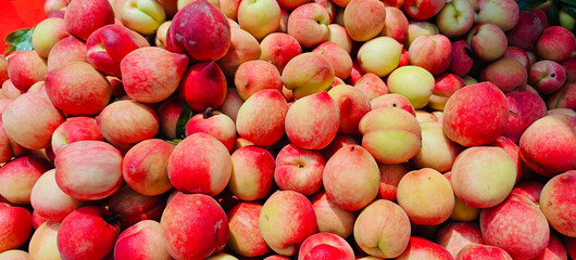 A pile of fresh ripe peach fruits.	
