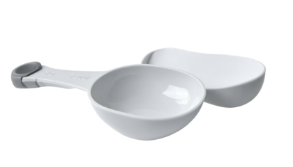Two white measuring spoons stacked