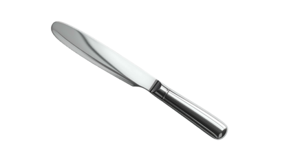 Gleaming silver butter knife angled on a stark black background