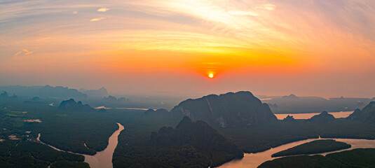 Aerial view Deltas of the river and mangroves in heart island in sweet sky at sunrise. Canals winding in the mangroves create a heart-shaped island. beautiful tropical landscape background