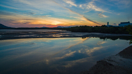 Under a radiant dusk sky, hues of orange and pink melt into tranquil waters. The lake captures every shimmer of the fading light offering a peaceful moment of reflection and harmony with nature.