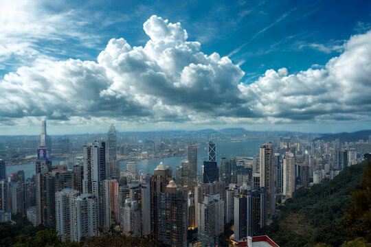 Vast cityscape under dramatic clouds and blue sky