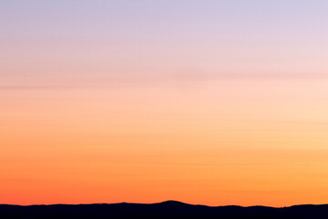 sunset in the sky Shows a sunset sky with pink and orange hues, no people. Full-frame composition, warm color tone. Realistic style, background is the sky