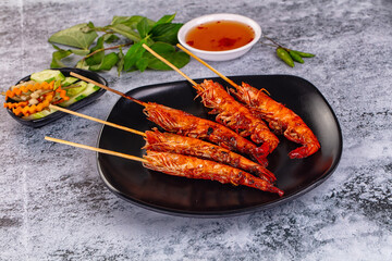 Grilled prawn skewer served sauce