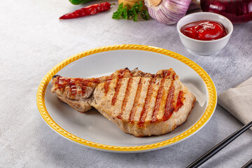 Tasty hot grilled bone steak served sauce