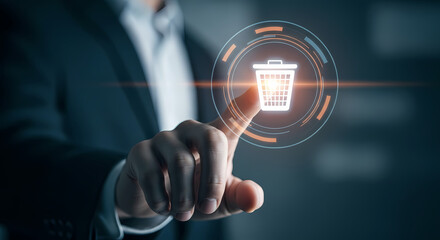 A businessman's finger touches a digital trash can icon, symbolizing data deletion, waste management, and the concept of removing unwanted information.