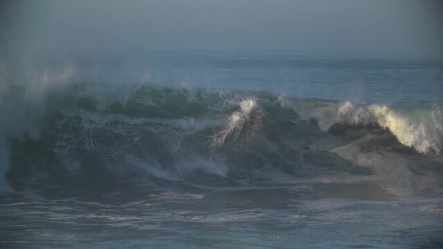 Bodyboarder kicking out of large storm waves
