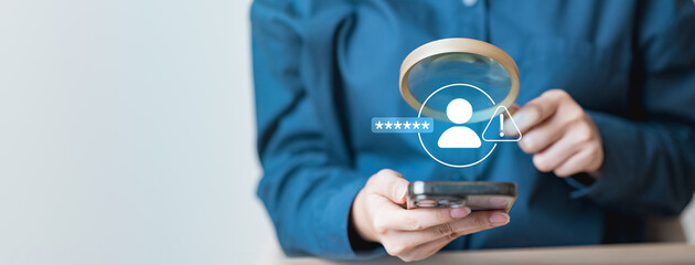 A woman turning on location access on a smartphone while working on a laptop, symbolizing privacy settings, permission control, and digital security management.