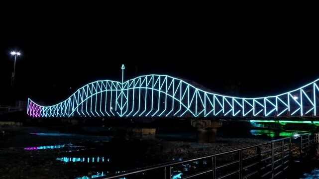 When the nearby bridge was illuminated in multicolor during 'Ganga Aarti' ceremony in Haridwar, Uttarakhand, India