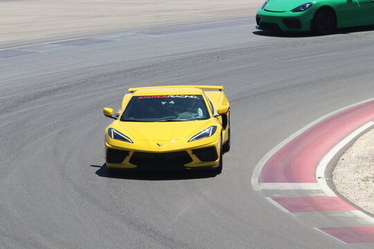 Yellow corvette c8 on racetrack