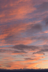 sunset in the sky Displays a sky with pink and orange hues, likely a sunrise or sunset. No people. Full-frame composition, warm color tone. Realistic style, background is sky