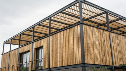 Fototapeta premium bamboo building materials Modern bamboo building with a spacious upper terrace and natural materials, showcasing sustainable architecture.