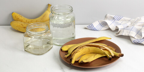 Banana peel fertilizer making with water jars on counter