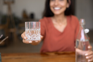 Close up of glass with clear water in female hand