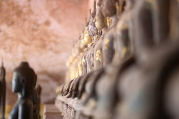 Golden ancient Buddha statue in a Lao temple with a serene meditation face, an iconic religious Asian sculpture representing peace and spirituality, Vientiane, Laos