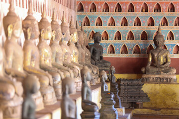 Golden ancient Buddha statue in a Lao temple with a serene meditation face, an iconic religious Asian sculpture representing peace and spirituality, Vientiane, Laos