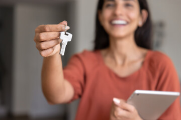 Close up of female hand holding key from new apartment