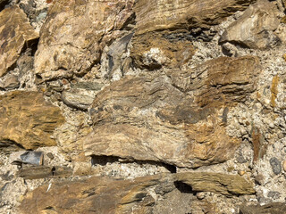 Natural sedimentary rock formation with varied textures and layers