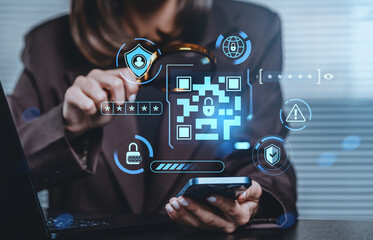 Cybersecurity concept with QR code and digital lock icons over businesswoman using smartphone and laptop in office environment for secure access.