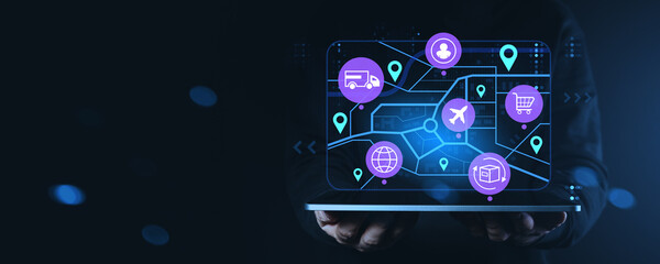 Digital supply chain management interface with logistics icons on transparent screen held by hands in dark background representing global commerce concept.
