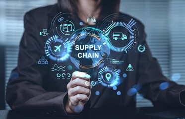 Businessperson analyzing futuristic supply chain concept with logistics holograms and digital data interface in blue tones on office background.