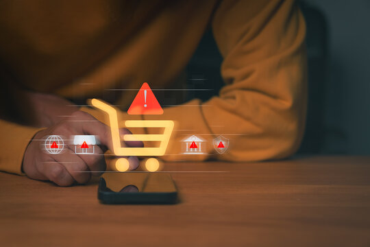 Person using smartphone with digital shopping cart and warning icons, symbolizing online shopping fraud, e-commerce scam, and payment risk. Concept of cybersecurity and consumer protection awareness.
