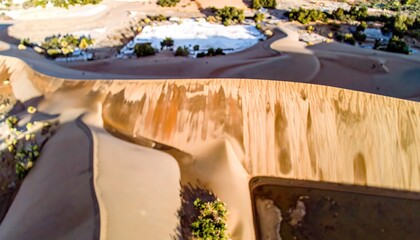 Aerial View of Beige Sand Dunes with Warm Light and Textured Patterns