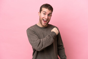 Fototapeta premium Young caucasian man isolated on pink background celebrating a victory