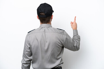 Young safeguard caucasian man isolated on white background pointing back with the index finger