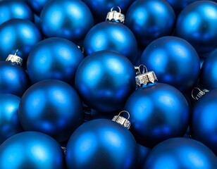 Close-up of a cluster of blue spherical decorations with silver caps, capturing a festive, shiny surface