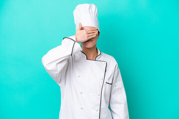 Young caucasian chef woman isolated on blue background covering eyes by hands. Do not want to see...
