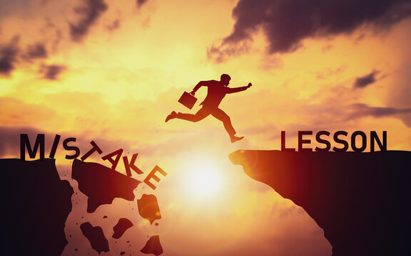 Silhouette of businessman jumping over cliff from word Mistake to Lesson. Concept of determination and learning from mistakes to create opportunities to overcome and grow in future business path.