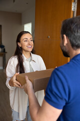 Happy female client take carton box from polite delivery man