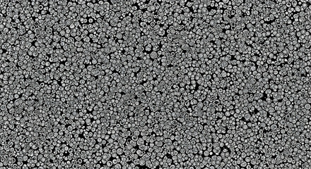 Dense, textured abstract background composed of numerous small, irregular grey shapes, creating a visually complex and organic surface