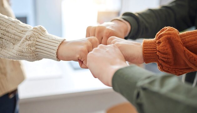 Dynamic teamwork with a supportive team fist bumping in a bright office representing collaboration, unity, and shared success for modern business concepts