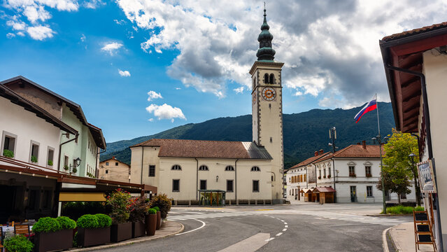 Kovarid village center square with church with bell tower and buildings of mountain architecture, Slovenia