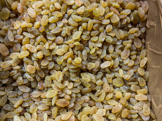 pile of golden raisins, also known as kishmish. Raisins are dried grapes,