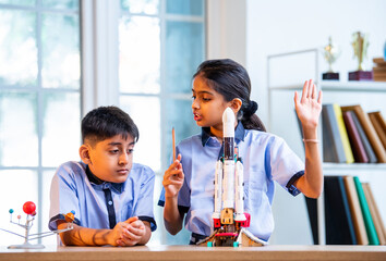 Indian students explore space rocket model in classroom while learning aerospace concepts in uniform