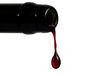 Bottle pouring last drop of red wine, liquid leaving bottle neck, showing final splash, transparent background