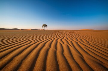 Naklejka premium Solitary Life and Survival in the Arid Wilderness Under a Clear Blue Sky