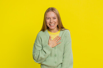 Happy middle-aged mature woman laughing out loud after hearing ridiculous anecdote, reaction on funny joke feeling carefree amused. Positive expressions. Young adult girl isolated on yellow background