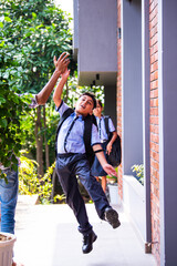 Indian School kids greeting teacher with hi-five while entering school in uniform happily