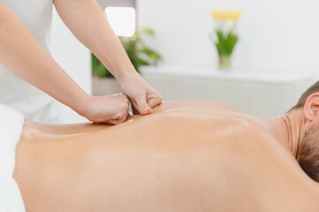 Obraz premium Handsome man receiving massage at spa
